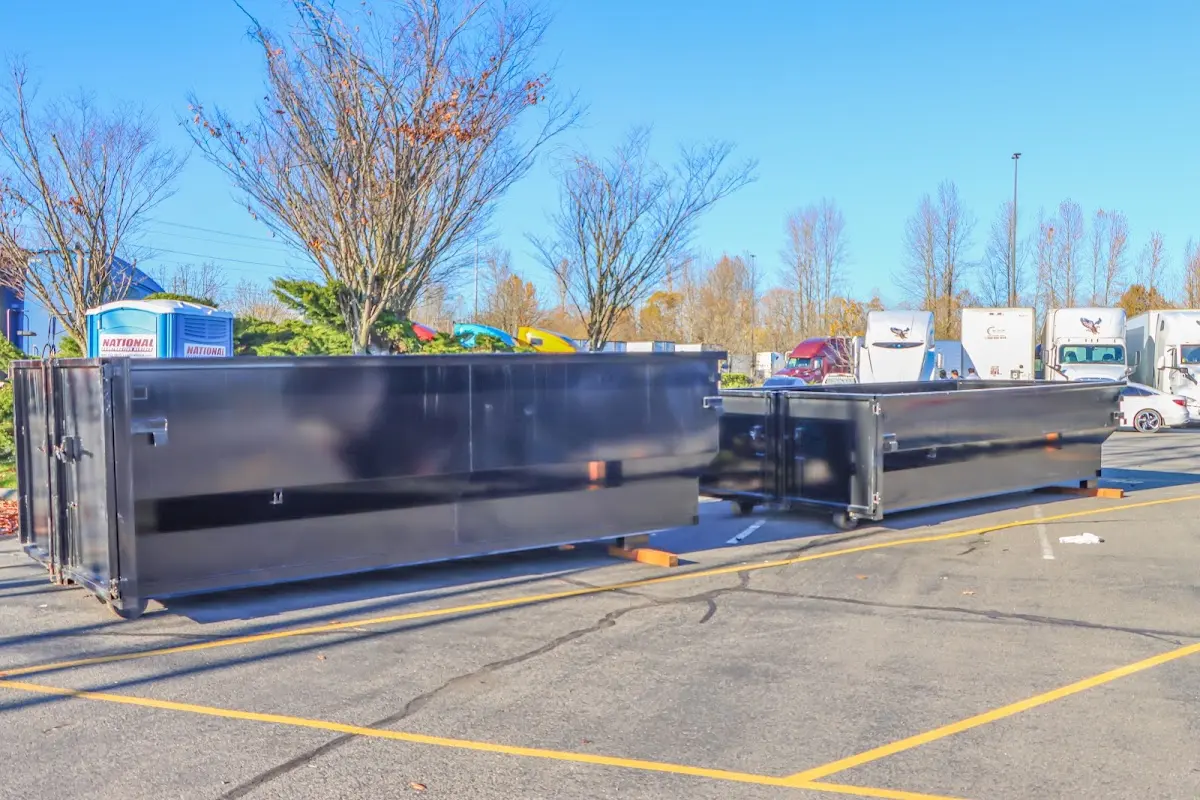 Professional dumpster rental service with roll-off container on residential driveway in Calipatria